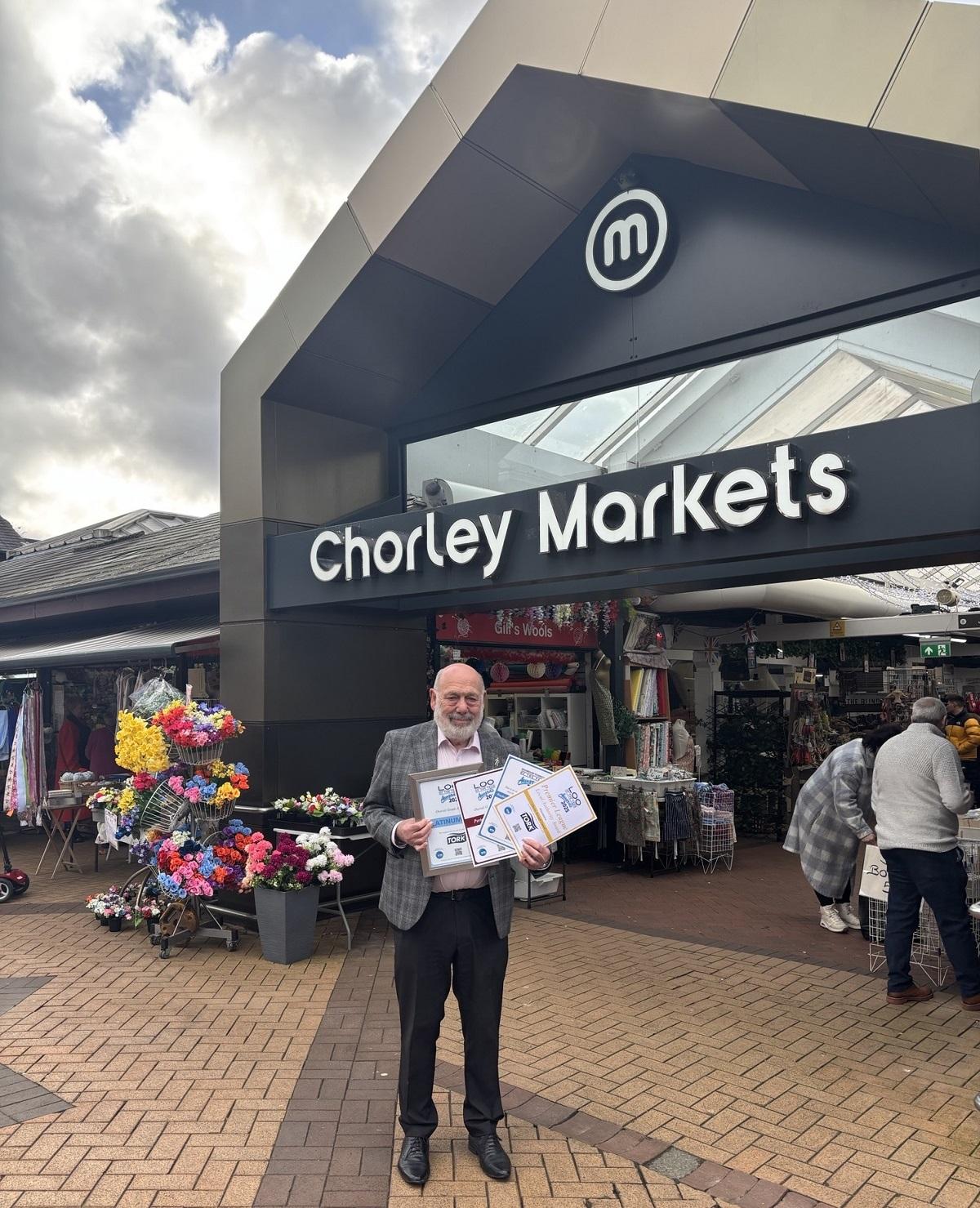 Cllr Danny Gee outside the entrance to Chorley's covered market